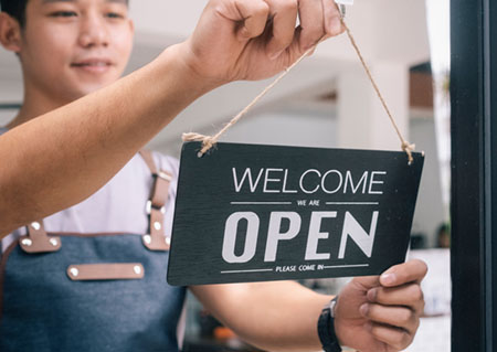 Woman hanging welcome sign