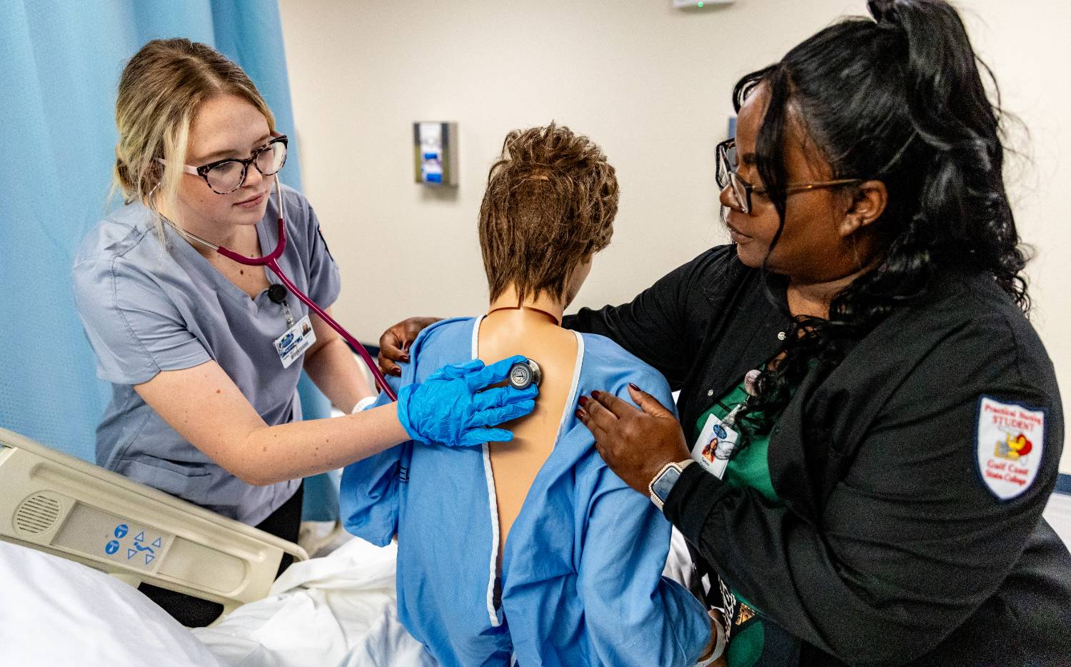 Student checking a patient's eyes