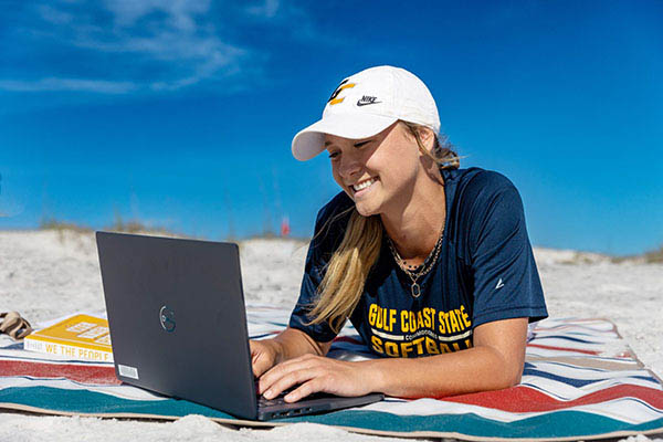 Student on Computer on the beach